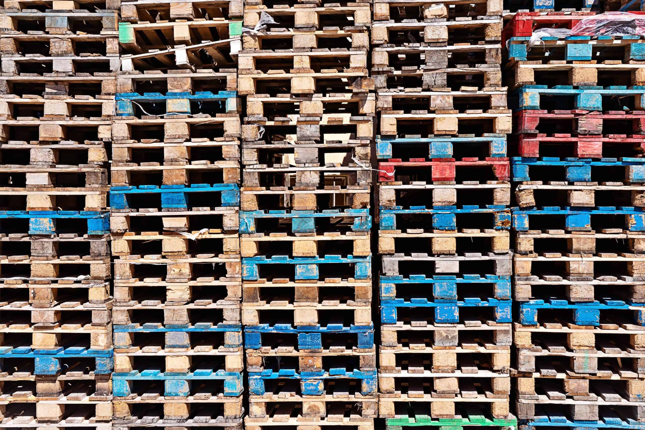 Abstract wooden pallets surface background, stack of pallet in warehouse.