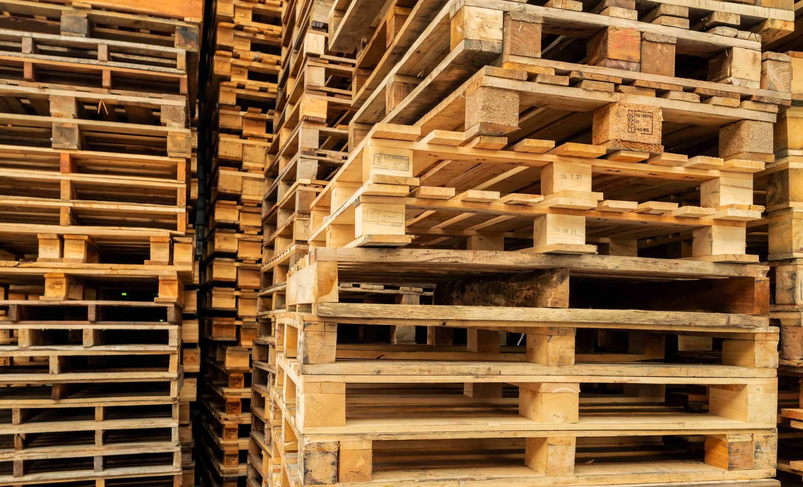 Stack of wooden pallet. Industrial wood pallet at factory warehouse.