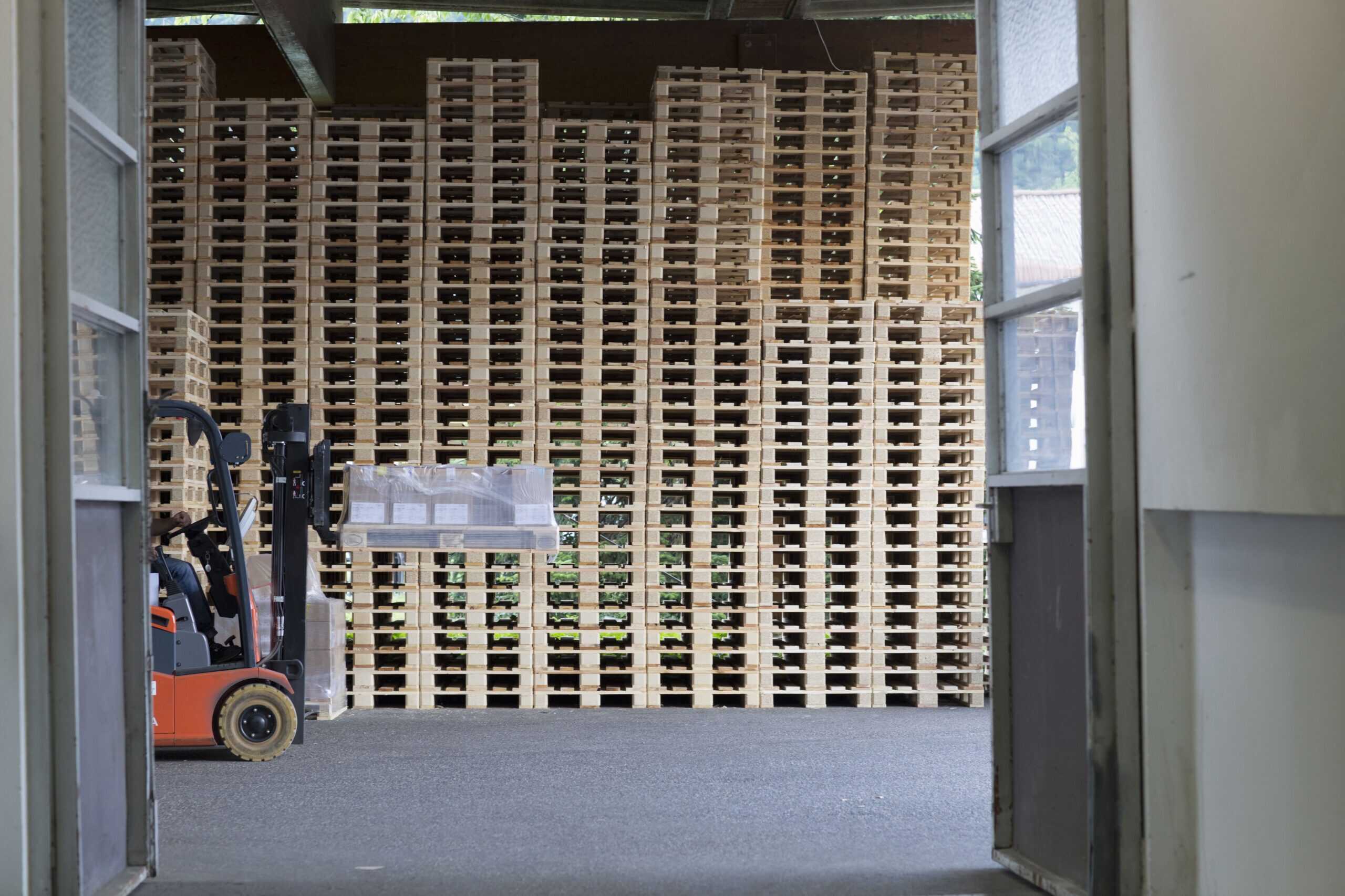 Factory worker using forklift truck