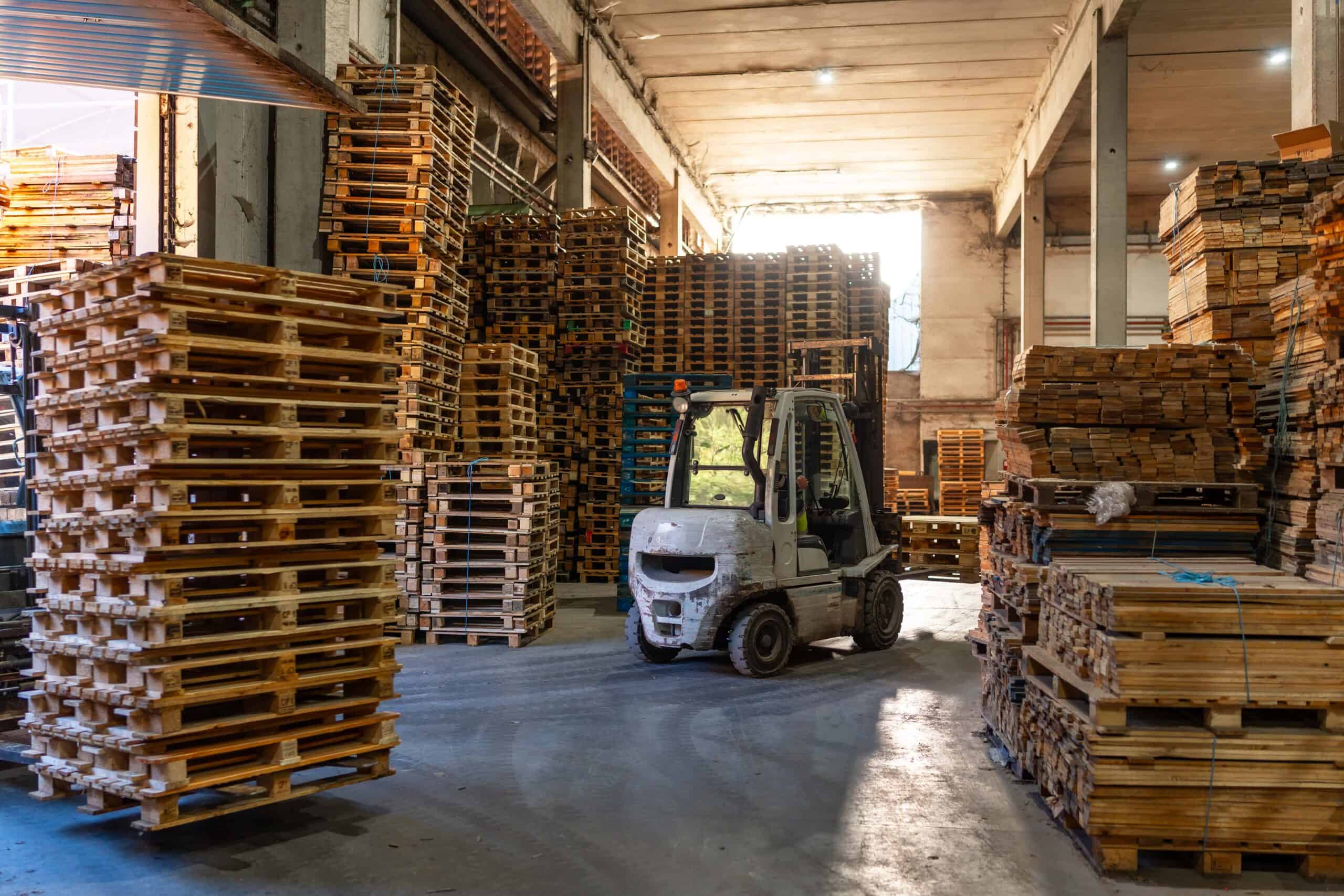 Forklift in a pallet storage room in a recycling plant