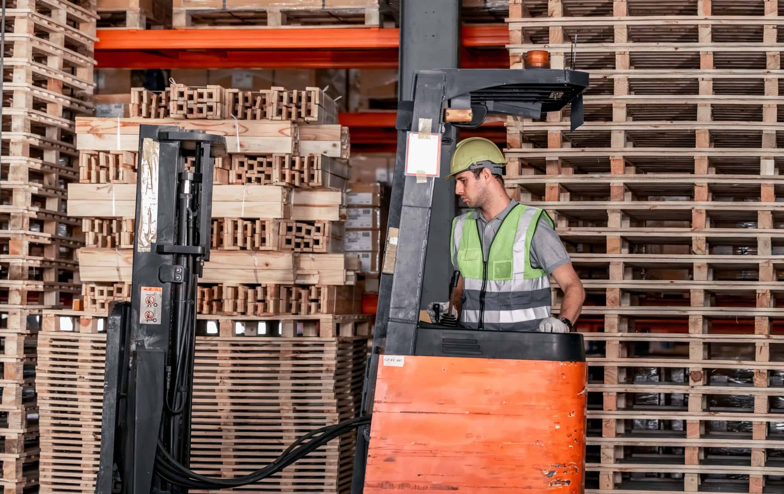 Warehouse forklift operator moves, stores merchandise.